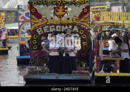 Representatives of La Flor Más Del Ejido in Xochimilco, Mexico City, aboard a canoe decorated with flowers during a tour of the Embarcadero Nuevo de Nativitas on the occasion of this contest, which aims to highlight the diversity of native women of this municipality, as well as to preserve and highlight the origins of the people who still preserve their customs and traditions. (Photo by Gerardo Vieyra/NurPhoto) Stock Photo