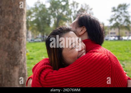 Two female friends hugging and having fun at the park. Friendship concept. Stock Photo
