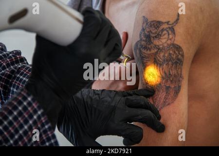 A Tattoo Artist Using a Tattoo Machine · Free Stock Photo