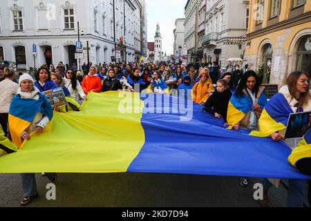 People attend 'Mothers' March' as part of Stand with Ukraine international protest, in Krakow, Poland on April 10, 2022. Ukrainian mothers and supporters gathered to demonstrate solidarity with all victims of Russian attacks on Ukraine. (Photo by Beata Zawrzel/NurPhoto) Stock Photo