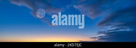 A Detailed Image Of A Full Moon Set Against A Blue Daytime Sky In Banner Image Format Stock Photo