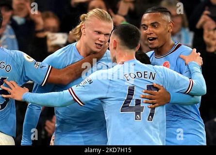 Manchester City's Erling Haaland (left) celebrates scoring their side's second goal of the game with team-mates Phil Foden and Manuel Akanji (right) during the Premier League match at the Etihad Stadium, Manchester. Picture date: Saturday November 5, 2022. Stock Photo