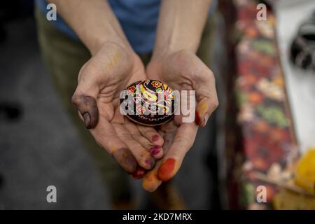 Olga Sokiran, a member of Northeastern University’s Ukrainian Cultural Club, holds her finished Pysanka (Ukrainian Easter egg). Students held a Pysanka-making workshop on campus, ahead of Ukrainian Easter. Designs are drawn with wax and the eggs are dyed in layers, beginning with the lightest color and working up to red or black. At the end, the wax is removed to reveal an elaborately decorated egg. (Photo by Jodi Hilton/NurPhoto) Stock Photo