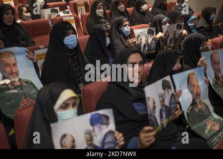 Iranian veiled women hold posters with portraits of Iran’s Supreme Leader Ayatollah Ali Khamenei, former commander of the IRGC’s Quds Force Qasem Soleimani, and former commander of the Basij Paramilitary Force, Mohammad Hossein-Zadeh Hejazi, during a ceremony in the Iranian Interior Ministry building in downtown Tehran, on April 14, 2022. (Photo by Morteza Nikoubazl/NurPhoto) Stock Photo