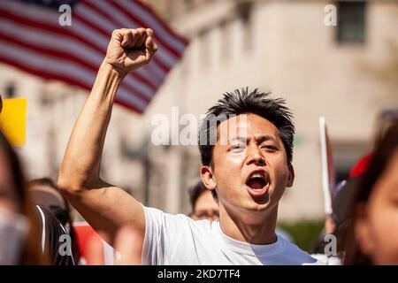 A demonstrator emphatically calls for democracy and civilian rule in Myanmar during a multi-ethnic march marking the first anniversary of the National Unity Government. (Photo by Allison Bailey/NurPhoto) Stock Photo