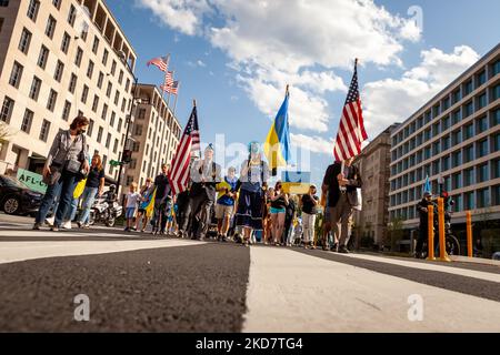 Demonstrators march from the White House to the residence of the Russian ambassador during a protest against the war in Ukraine. In addition to the daily rally, demonstrators held a vigil outside the residence to demand an end to what they claim is genocide. Ukraine’s supporters continue to demand a no-fly zone over Ukraine, additional military assistance, and exclusion of all Russian banks from SWIFT. (Photo by Allison Bailey/NurPhoto) Stock Photo