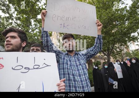 An Iranian man holds-up a placard during a protest gathering in front of the Sweden Embassy in northern Tehran to condemn Koran burning in Sweden, on April 18, 2022. (Photo by Morteza Nikoubazl/NurPhoto) Stock Photo