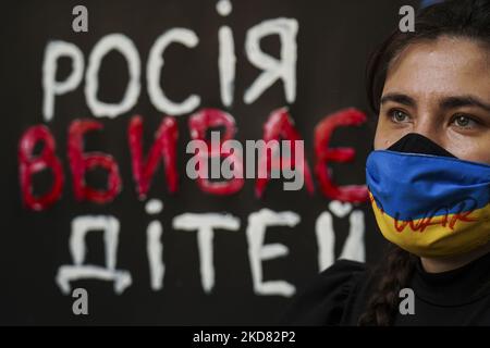 A protester wearing a Ukrainian flag face mask with the message ' No war ' during a demonstration against Russia's invasion of Ukraine and the deaths of children in the city of Mariupol outside the Russian embassy in Bangkok on April 20, 2022. (Photo by Anusak Laowilas/NurPhoto) Stock Photo