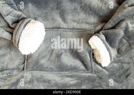 Gray warm terry jacket with a pocket as a close-up background Stock Photo