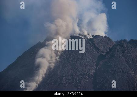 Mount Merapi, a volcanic mountain spews volcanic material as it erupts several times as seen from Turgo village, Sleman district in Yogyakarta, Indonesia on December 23, 2021. Merapi is located in one of the most densely populated parts of Java with over 11,000 people living on the slopes of the mountain. Mount Merapi, measuring 2,968 metres high, is known as one of the most active volcanoes in Indonesia, with an eruption occurring every two to five years. (Photo by Garry Lotulung/NurPhoto) Stock Photo