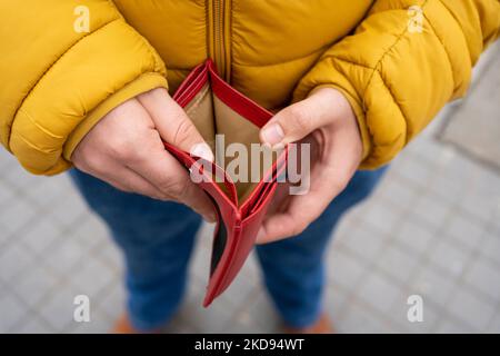 man hand open empty purse looking for money having problem bankrupt broke after credit card payday Stock Photo
