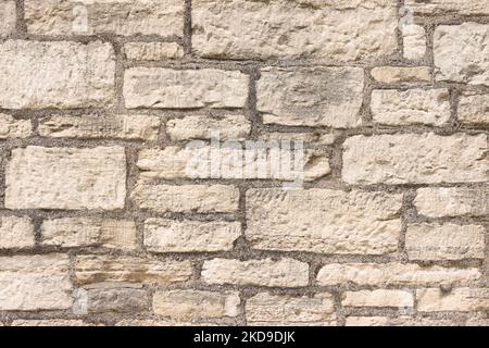 Old stone wall, UK. Full frame pattern or texture of ancient wall made of sandstone blocks Stock Photo
