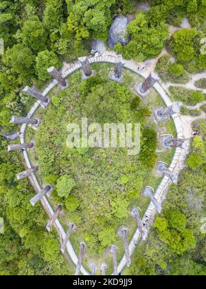 A detail of the wisdom path in form of infinity which engraves on wooden pillars the verses of the ''Heart Sutra'', a Buddhist religious text, and which is found in the Ngong Ping monastery in Lantau island. View by drone,in Hong Kong, China, on May 10, 2022. (Photo by Marc Fernandes/NurPhoto) Stock Photo