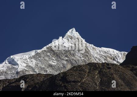 Langtang Lirung peak as seen from Langtang village, part of the Langtang Himal mountain in Nepal with the highest point at the elevation of 7234m or 23734 ft. Langtang Lirung is the 99th tallest mountain in the world and the summit was reached for the first time in 1978. On April 25, 2015, a massive 7.8 magnitude earthquake resulted in an avalanche and landslide in Langtang village directly killing 243 and vanishing the village. Langtang National Park is a popular trekking and travel destination for foreign trekkers and locals, people living in the village are Tamang Tibetan with origin from T Stock Photo