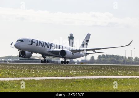 Finnair Airbus A350-900 aircraft as seen during rotation, take off and fly phase as the plane is departing from Amsterdam Schiphol Airport AMS EHAM. The modern wide-body A350 passenger jet airplane has the registration OH-LWM. Finnair is the Finnish flag carrier and member of Oneworld aviation alliance group. The plane is flying to Helsinki, Finland. As the Covid-19 Coronavirus pandemic measures are suspended the aviation, travel and tourism industry are having increased demand for flights. Amsterdam, The Netherlands on May 4, 2022 (Photo by Nicolas Economou/NurPhoto) Stock Photo