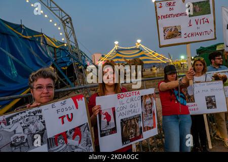 Volunteers show signs during the protest against the exploitation of animals in the Orfei circus of Molfetta on May 14, 2022. Sit-in protest against the exploitation of animals in entertainment shows, near the settlement area of ??the Orfei circus, currently present in the city of Molfetta. The garrison involved a group of citizens of Molfetta, led by the volunteers of the animal rights association 'Lo Stregatto - Molfetta'(Photo by Davide Pischettola/NurPhoto) Stock Photo