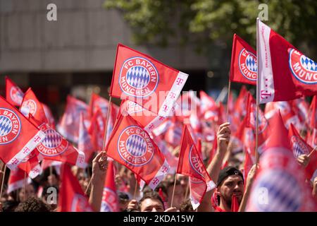 Fans of FC Bayern Munich celebrate on Marienplatz in front of Munich City  Hall, where the team of the German football record champion presents itself  on the balcony after the reception by