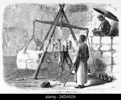 Weighing cotton at Bombay, India, for the English market. November 1862. 19th century illustration from Frank Leslie's Illustrated Newspaper Stock Photo