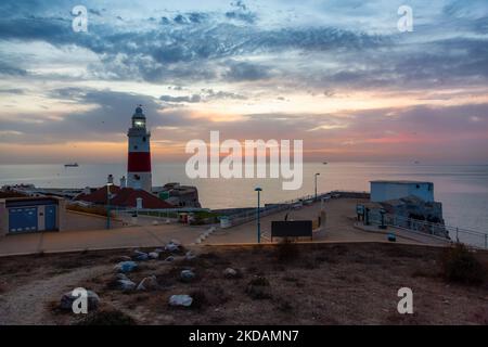 Europa Point Lighthouse with sea in background. Colorful Cloudy Sunrise Sky. Gibraltar Stock Photo