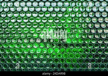 Glass bottles green. Green glass bottles of beer. Wall formed by green bottles. Green bottles background. Empty Glass Bottle with Lighting Stock Photo