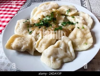 Filled dumplings called Pierogi are seen in a milk bar's table in Krakow, Poland on May 24, 2022. (Photo by Jakub Porzycki/NurPhoto) Stock Photo