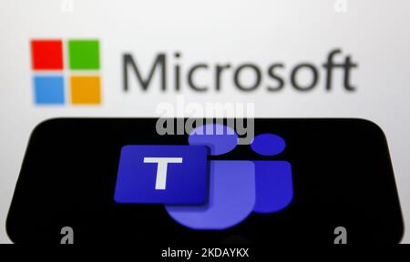 Microsoft Teams logo displayed on a phone screen and Microsoft logo displayed on a screen in the background are seen in this illustration photo taken in Krakow, Poland on May 26, 2022. (Photo Illustration by Jakub Porzycki/NurPhoto) Stock Photo