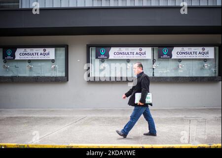 A person stands in front of a information window set for the Presidential Elections in Bogota, Colombia May 26, 2022. Presidential elections will take place on May 29. (Photo by Sebastian Barros/NurPhoto) Stock Photo