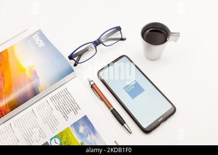 In this photo illustration a Goldman Sachs logo seen displayed on a smartphone screen on a desk next to a cafe, a pen, glasses and a magazine in Athens, Greece on May 27, 2022. (Photo Illustration by Nikolas Kokovlis/NurPhoto) Stock Photo