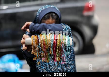 A Palestinian girl displays and sells prayer beads on a street in Gaza City, on May 29, 2022 (Photo by Majdi Fathi/NurPhoto) Stock Photo