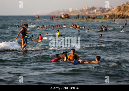 Palestinians enjoy the beach of the sea in Deir al-Balah in the center of the Gaza Strip, during a hot day, on May 31, 2022. (Photo by Majdi Fathi/NurPhoto) Stock Photo