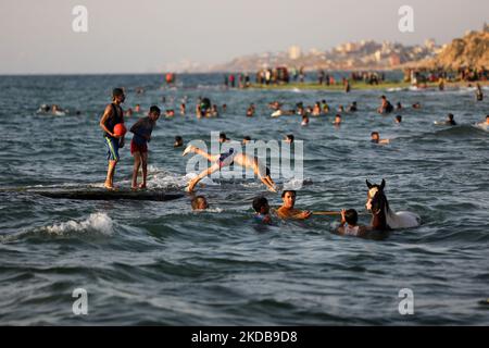Palestinians enjoy the beach of the sea in Deir al-Balah in the center of the Gaza Strip, during a hot day, on May 31, 2022. (Photo by Majdi Fathi/NurPhoto) Stock Photo