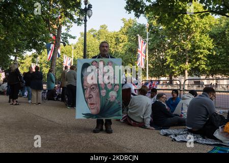 LONDON, UNITED KINGDOM - JUNE 02, 2022: Satirical artist Kaya Mar poses with a portait of Queen Elizabeth II with depictions of Prime Ministers who served during her reign placed on her headscarf ahead of the Trooping the Colour military parade to honour the official birthday Her Majesty the Queen and the Platinum Jubilee on June 02, 2022 in London, England. Millions of people in the UK are set to join the four-day celebrations marking the 70th year on the throne of Britain's longest-reigning monarch, Queen Elizabeth II, with over a billion viewers expected to watch the festivities around the  Stock Photo