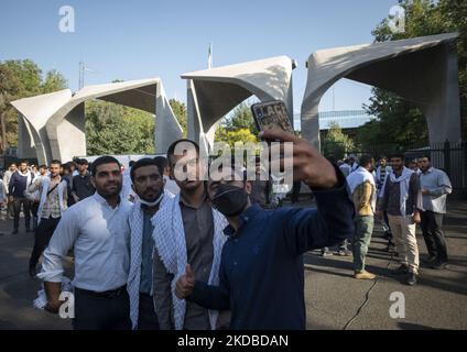 A group of Iranian Basiji (Members of Basij Paramilitary force) university students take a selfie while standing in front of the main gate of the University of Tehran before a rally to mark the thirty-third death anniversary of Founder of the Islamic Republic, Ayatollah Ruhollah Khomeini, June 3, 2022. (Photo by Morteza Nikoubazl/NurPhoto) Stock Photo