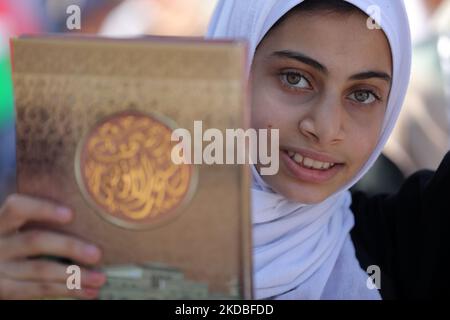 Palestinian girls wave national flags and the Holy Quran during a march to start a summer camp organized by the Hamas movement, in Gaza City, on June 04, 2022. (Photo by Majdi Fathi/NurPhoto) Stock Photo