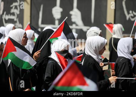 Palestinian girls wave national flags and the Holy Quran during a march to start a summer camp organized by the Hamas movement, in Gaza City, on June 04, 2022. (Photo by Majdi Fathi/NurPhoto) Stock Photo