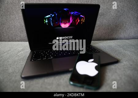 Apple website displayed on a laptop screen and Apple logo displayed on a phone screen are seen in this illustration photo taken in Krakow, Poland on June 6, 2022. This year's Apple Worldwide Developers Conference begins today. (Photo by Jakub Porzycki/NurPhoto) Stock Photo