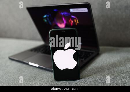 Apple website displayed on a laptop screen and Apple logo displayed on a phone screen are seen in this illustration photo taken in Krakow, Poland on June 6, 2022. This year's Apple Worldwide Developers Conference begins today. (Photo by Jakub Porzycki/NurPhoto) Stock Photo