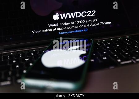 Apple website displayed on a laptop screen and Apple logo displayed on a phone screen are seen in this illustration photo taken in Krakow, Poland on June 6, 2022. This year's Apple Worldwide Developers Conference begins today. (Photo by Jakub Porzycki/NurPhoto) Stock Photo