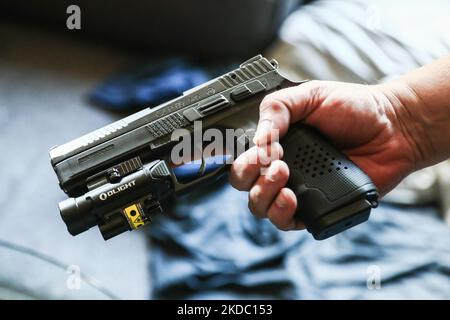 A person holds CZ P-09 handgun in this illustration photo taken in Krakow, Poland on June 11, 2022. (Photo by Jakub Porzycki/NurPhoto) Stock Photo