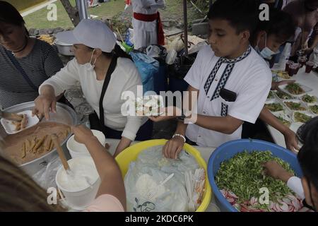 Preparation and distribution of enchiladas (a typical Mexican dish based on tortilla and green sauce) in the Ex-Convent of Culhuacán, Mexico City, on the occasion of Corpus Christi Thursday, better known as 'Dia de las Mulas' (Day of the Mules). Corpus Christi Day, which dates back to 13th century Belgium, is celebrated 60 days after Easter Sunday with the aim of proclaiming and increasing faith in Jesus Christ, which is found in the Blessed Sacrament, according to the Catholic Church. (Photo by Gerardo Vieyra/NurPhoto) Stock Photo