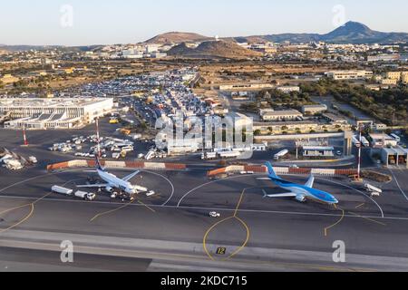 Aerial view of Heraklion airport with a LOT Polish Airlines and a TUI Boeing 737-800 aircraft parked at the tarmac. TUI Boeing 737 MAX aircraft as seen at Heraklion Airport in Crete island. Crete is a popular Mediterranean summer destination for tourism and holidays. TUI recently was on the news because of flight delays, disruption and cancellation chaos mostly created by the staff shortages that hit the aviation industry after the covid-19 coronavirus pandemic crisis. TUI Group is a German leisure, travel and tourism company. TUI Airways connects Heraklion to the United Kingdom and Ireland, B Stock Photo