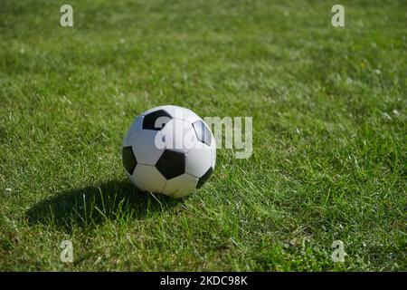 a closeup of a football on green grass in a field Stock Photo