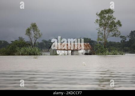 A damaged submerged house is seen after flash floods at Companiganj area in Sylhet, Bangladesh on June 20, 2022. At least 26 more people have died in monsoon flooding and lightning strikes in India, as millions remained marooned in the country and neighbouring Bangladesh, authorities said on June 20. (Photo by Syed Mahamudur Rahman/NurPhoto) Stock Photo