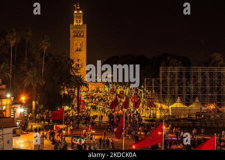 Morocco., Marrakech - the Jemma al Fna / Jemaa el-Fnaa  at night with the Kutubiyya Mosque or Koutoubia Mosque in the distance Stock Photo