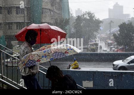 People carry umbrella during heavy rainfall in Mumbai, India, 27 June, 2022. (Photo by Indranil Aditya/NurPhoto) Stock Photo