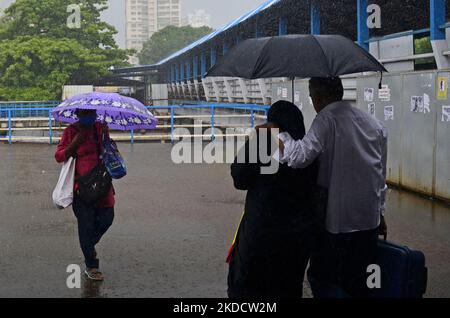 People carry umbrella during heavy rainfall in Mumbai, India, 27 June, 2022. (Photo by Indranil Aditya/NurPhoto) Stock Photo