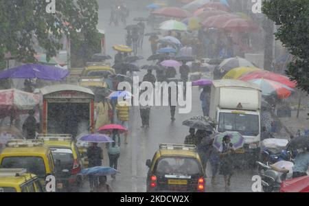 People carry umbrella during heavy rainfall in Mumbai, India, 27 June, 2022. (Photo by Indranil Aditya/NurPhoto) Stock Photo