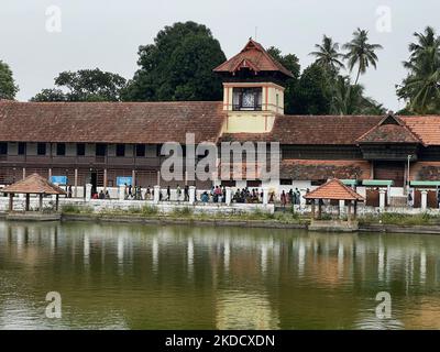 Methan Mani clock tower seen from across the Padmatheertham pond near the historic Sree Padmanabhaswamy Temple in Thiruvananthapuram (Trivandrum), Kerala, India, on May 12, 2022. The Methan Mani clock was installed in 1840's and was constructed with a highly complex pulley system. The clock has a unique appearance. Above the dial is the face of a bearded man with two rams on the side of his cheeks. When the clock strikes, the rams hit against the cheeks of the man. It have been installed in the 1840s during the reign of Maharaja Swathi Thirunal Rama Varma. (Photo by Creative Touch Imaging Ltd. Stock Photo