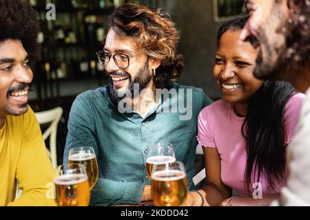 Happy multiracial business colleagues having a drink after work at brewery bar Stock Photo