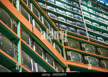 Old retro CRT TVs all over the wall Stock Photo